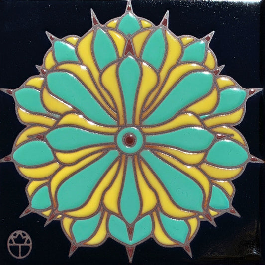 ceramic tile of an agave blossom on a black background